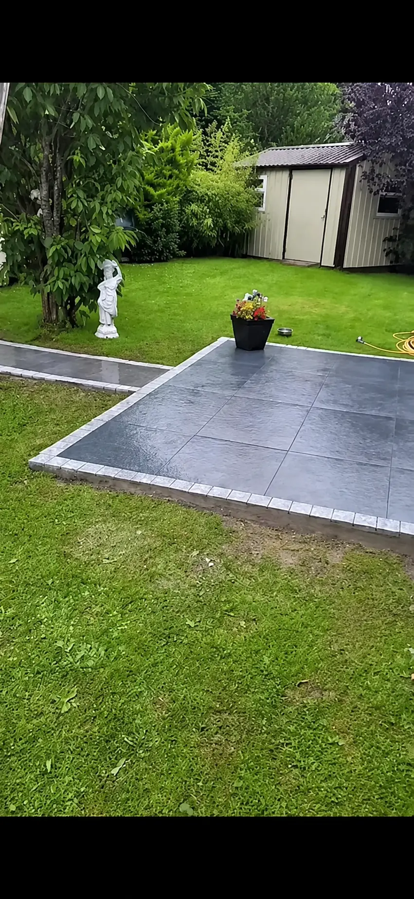 Turf lawn project beside a dark paved patio | Farrell Exteriors