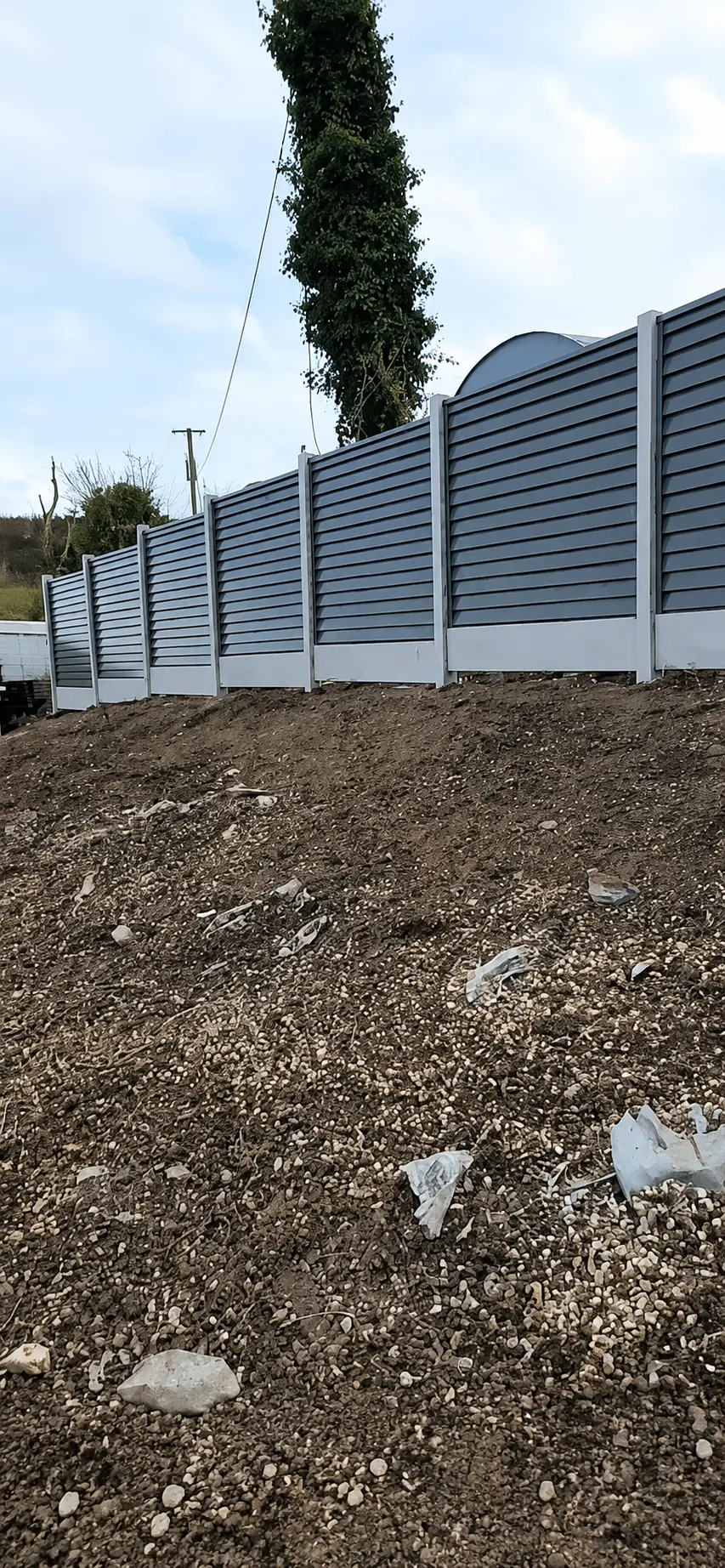 Composite fencing project completed in Laois along a raised boundary | Farrell Exteriors