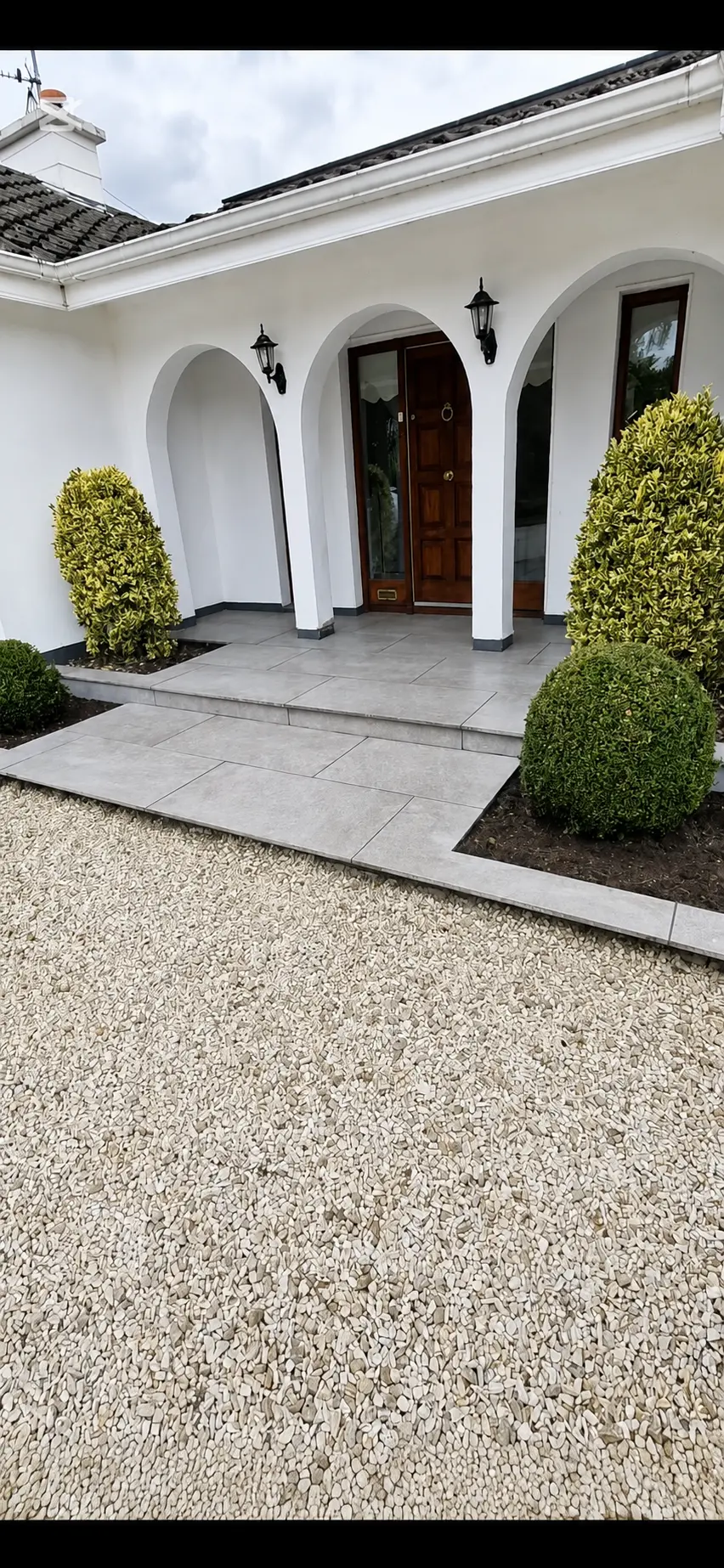 Driveway project in Carlow with a pale gravel finish and grey paved path | Farrell Exteriors
